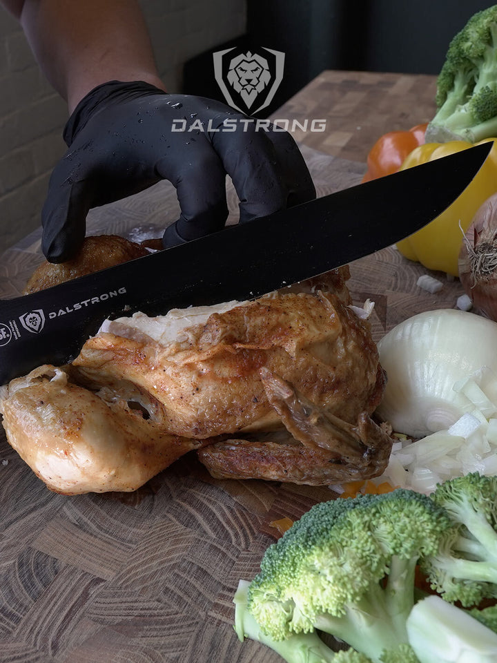 Dalstrong night shark series 10 inch offset carving knife with water proof handle slicing through a roasted chicken.
