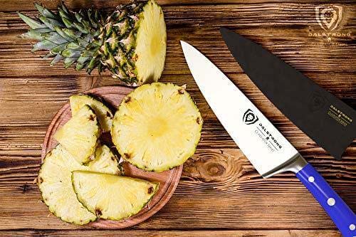 Dalstrong gladiator series 8 inch chef knife with blue handle and slices of pinapple on a wooden board.