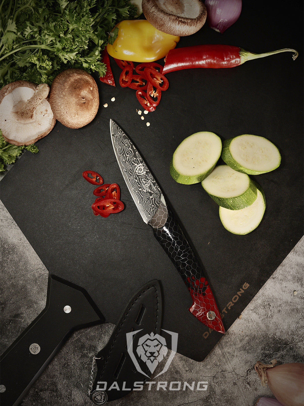 Dalstrong scorpion series 4 inch paring knife with red handle beside some mushrooms and chilli.