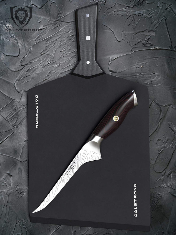Dalstrong infinity series fibre cutting board medium with a dalstrong knife on top of it.