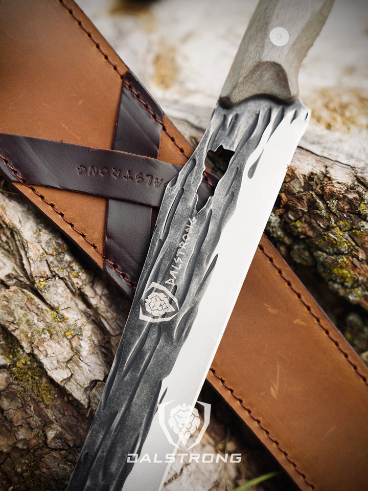 Dalstrong barbarian series 12 inch carving knife with wooden handle and its leather sheath beside it.