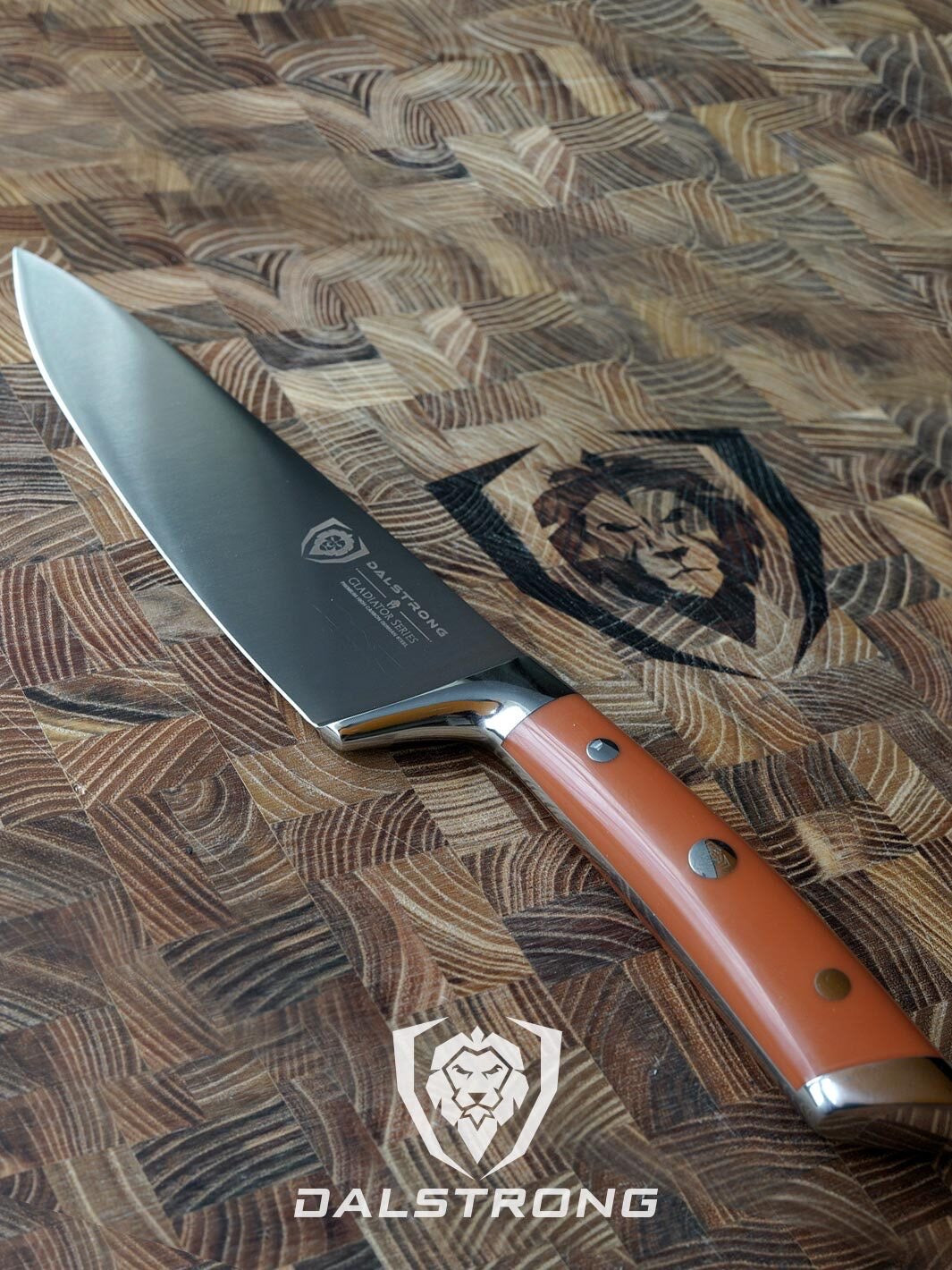 Dalstrong gladiator series 8 inch chef knife with orange handle on top of a dalstrong wooden board.