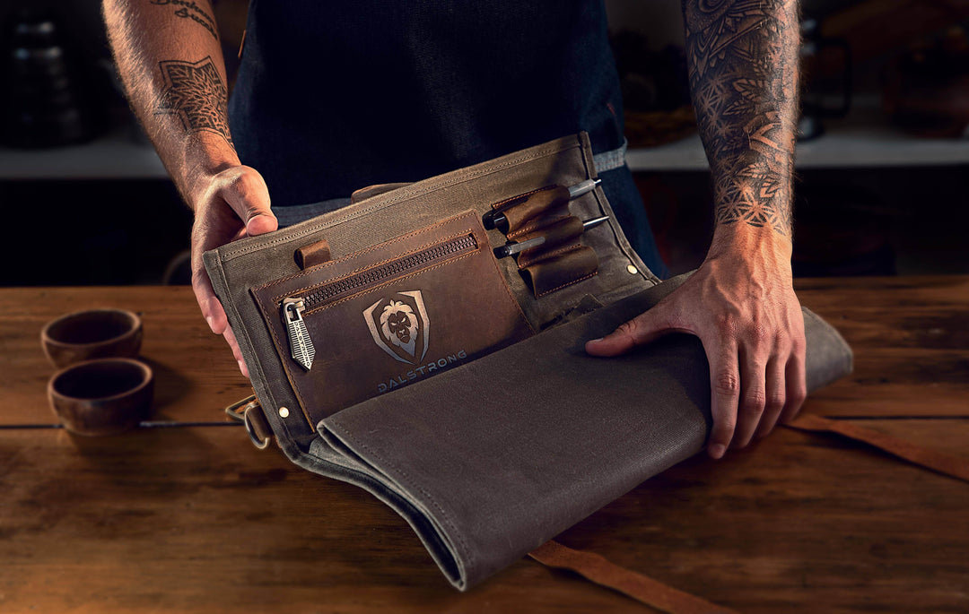 Dalstrong 12oz heavy-duty canvas and leather green nomad knife roll on a table.