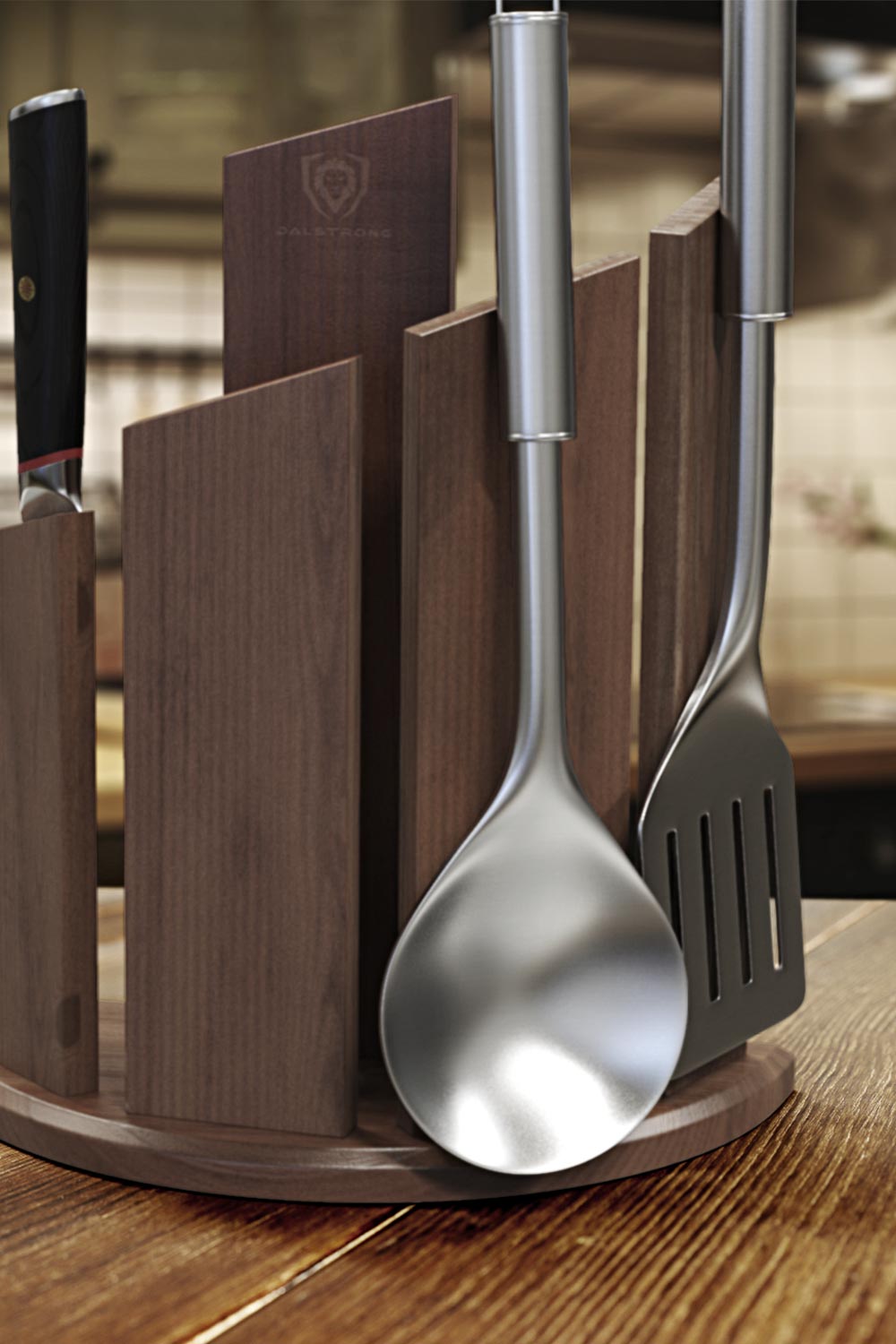 Dalstrong phantom series 6 piece knife set with dragon spire block and two kitchen utensils on it.