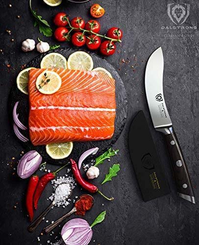 Dalstrong gladiator series 5.5 inch skinning and boning knife with black handle and sheath beside a fillet of salmon.