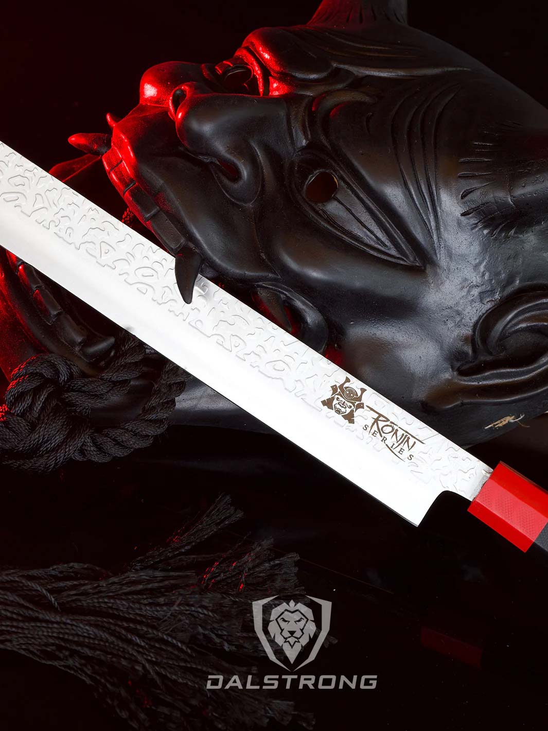 Dalstrong ronin series 12 inch slicing knife with black handle beside a samurai mask.