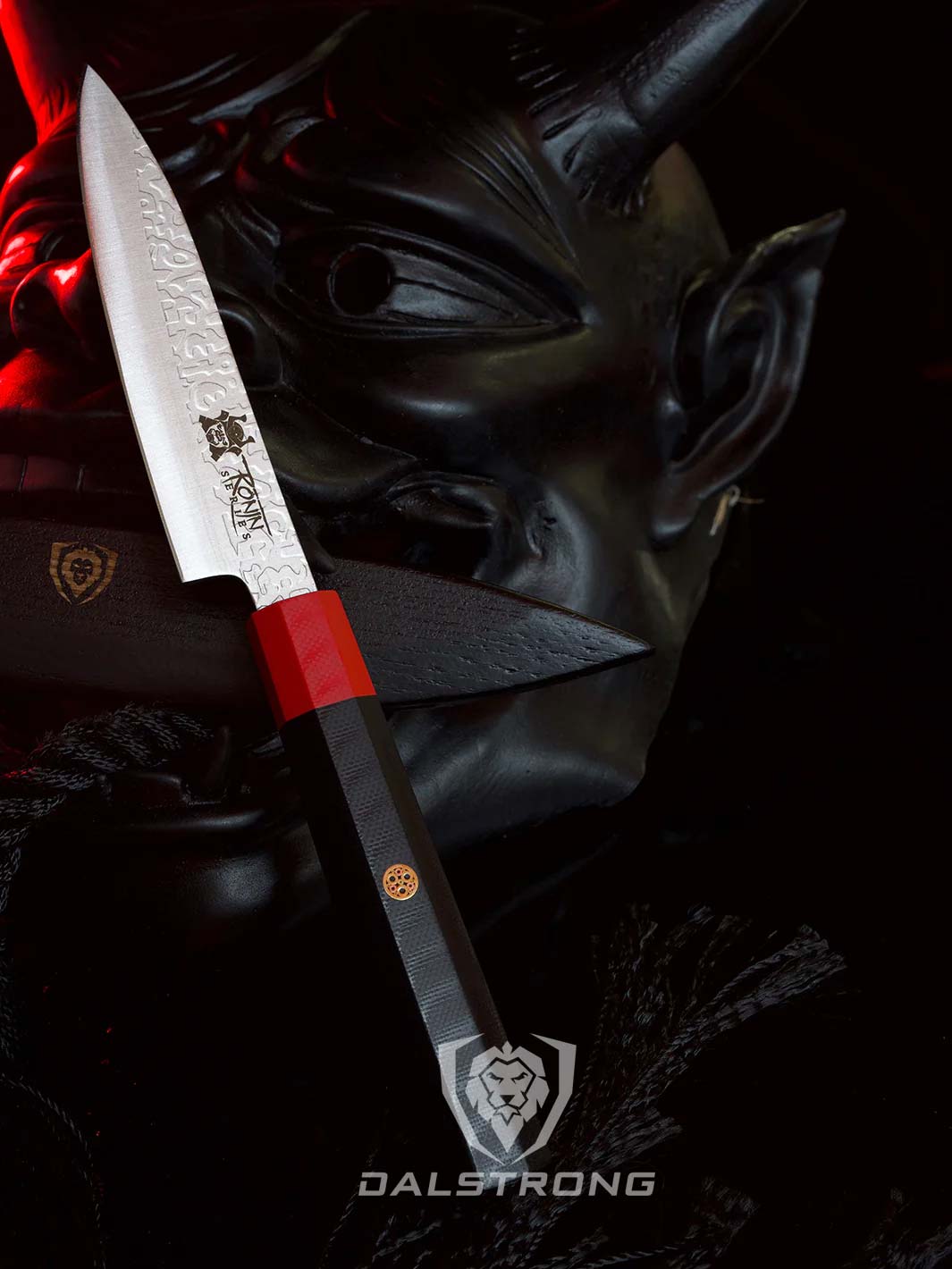 Dalstrong ronin series 4.5 inch paring knife with black handle beside a oni mask.