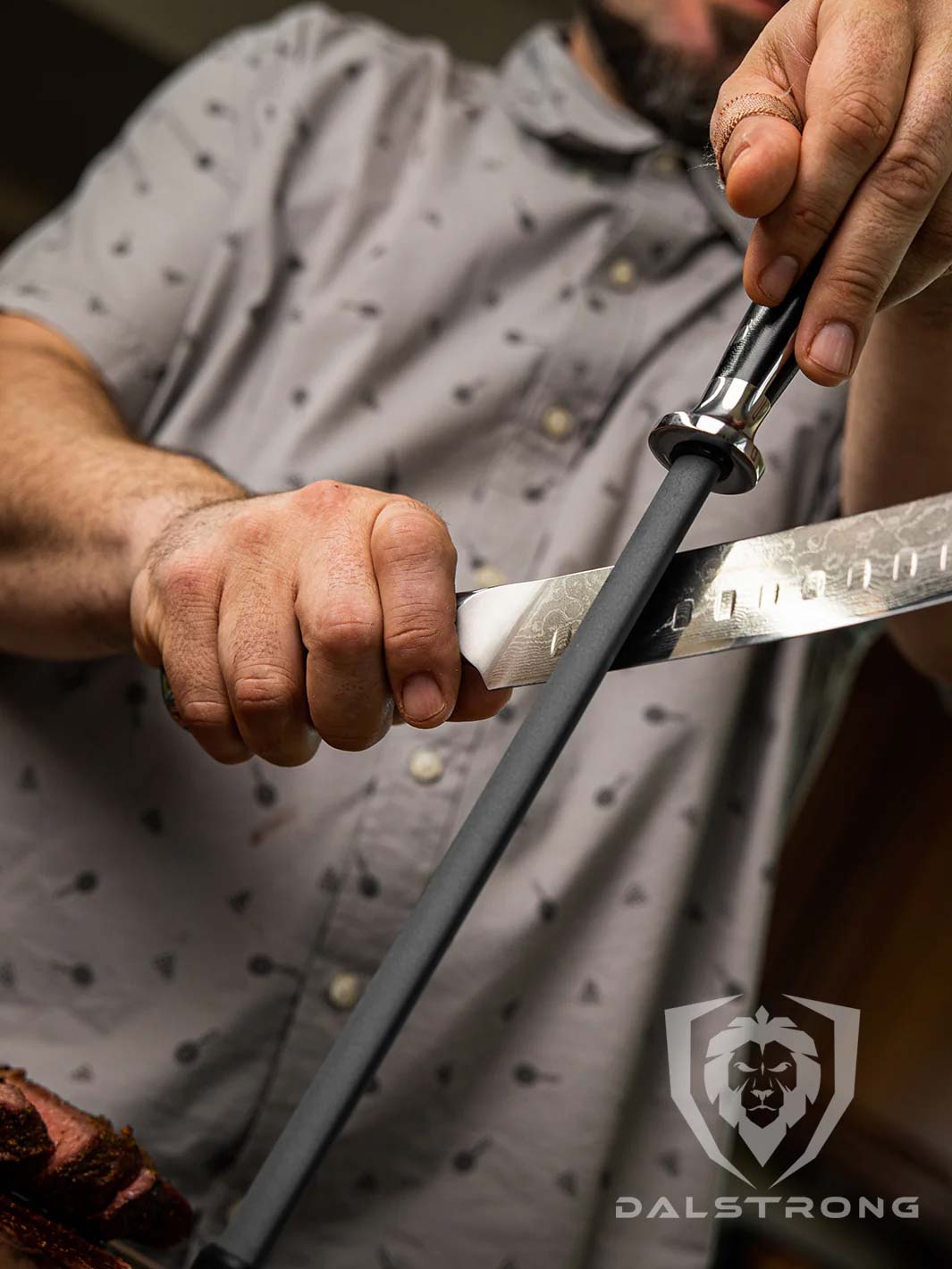 A man sharpening a knife using the Dalstrong 10 inch honing rod with ceramic coating.