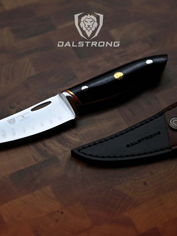 Dalstrong centurion series 6 inch curved boning knife beside it's sheath.