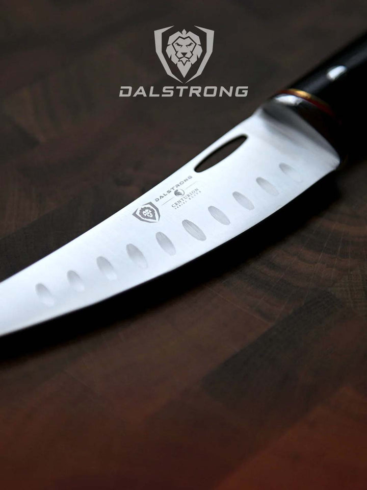 Dalstrong centurion series 6 inch curved boning knife on a cutting board showcasing it's blade.