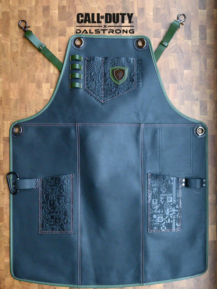 Dalstrong call of duty limited edition chef leather apron on a cutting board.