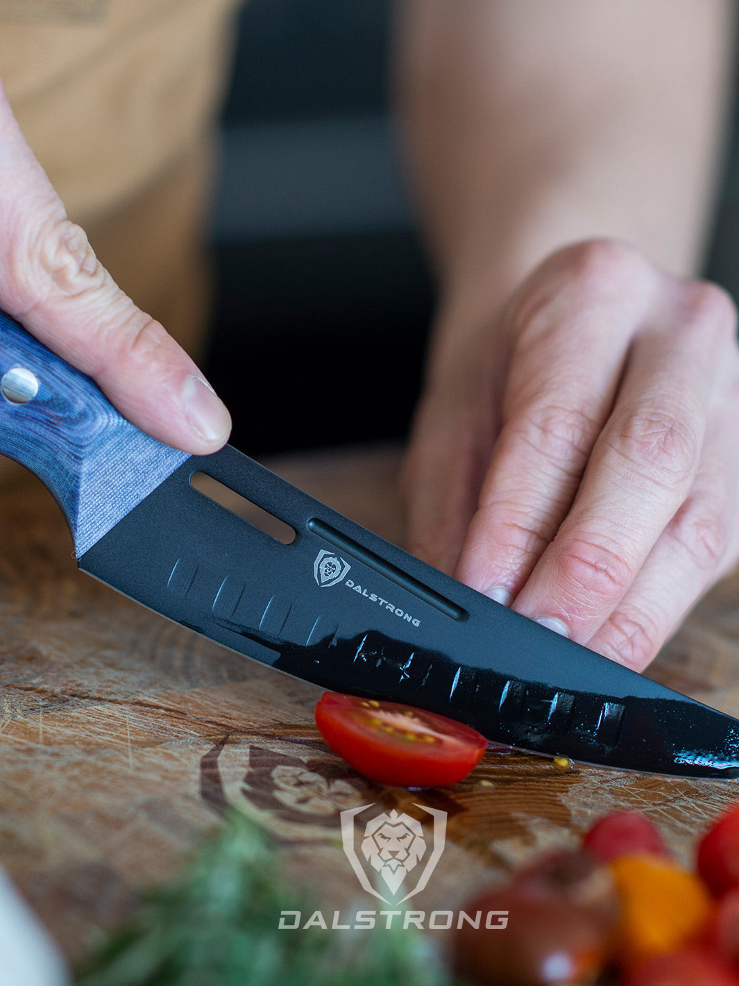 Dalstrong delta wolf series 6 inch curved fillet knife with a tomato cut in half.
