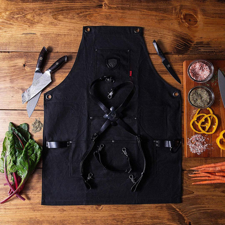 Dalstrong sous team apron heavy-duty waxed canvas chef's apron with dalstrong knives bside it.
