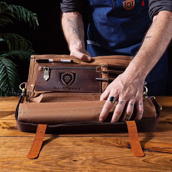 Dalstrong 12 oz heavy-duty canvas and leather nomad knife roll featuring the dalstrong logo on it.