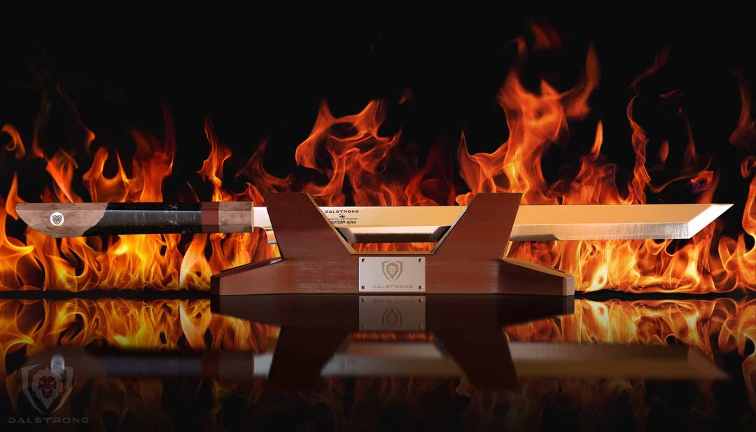 Dalstrong firestorm alpha series 17 inch helios slicer knife with stand behind a fire.