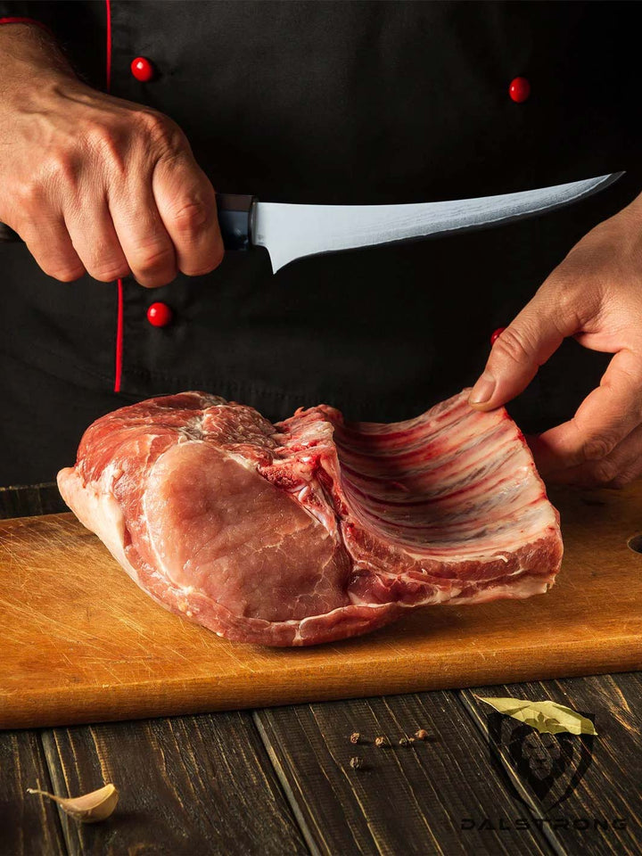 Dalstrong firestorm alpa series 6 inch curved boning knife with a huge cut of meat on a cutting board.