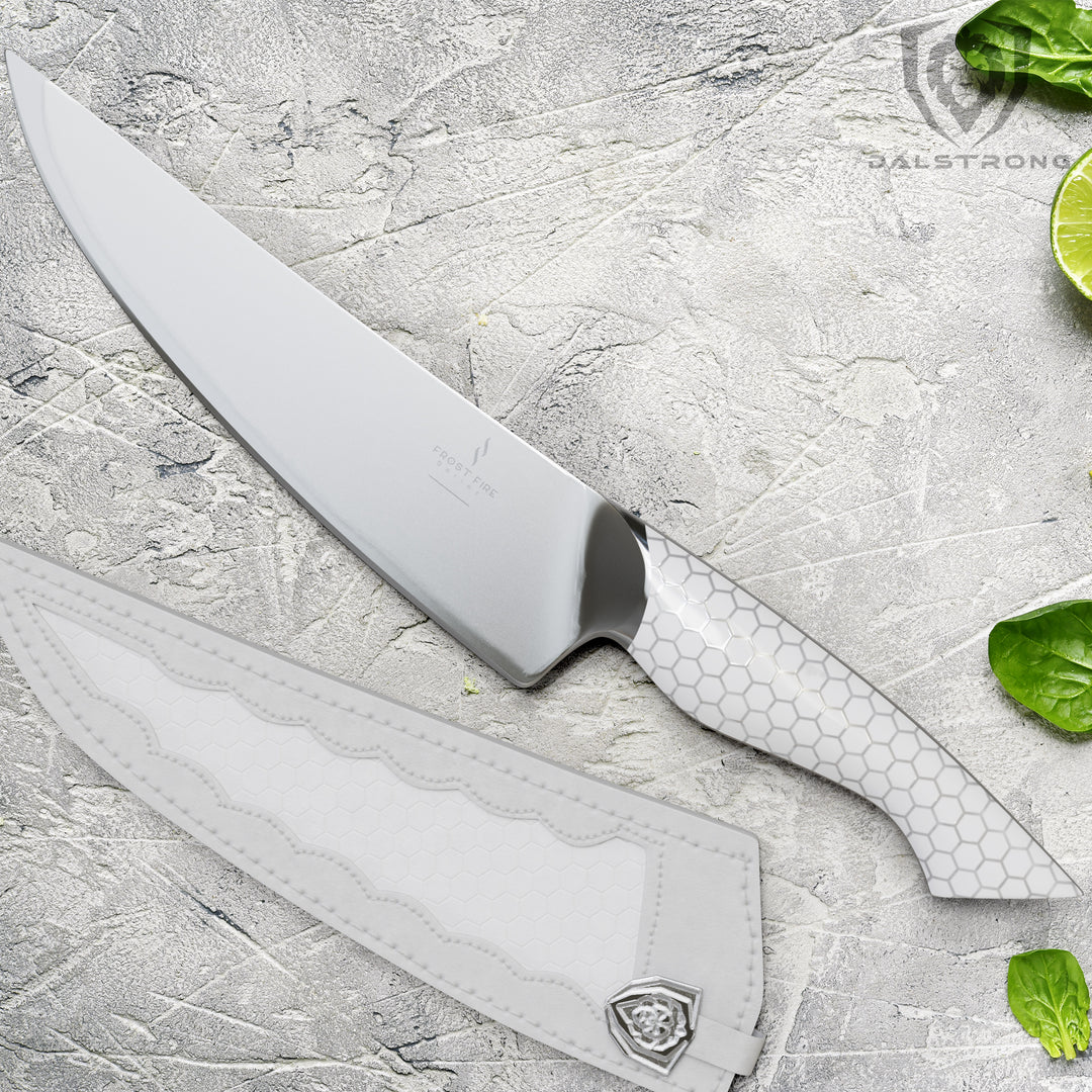 Dalstrong frost fire series 8 inch chef knife with white sheath beside a sliced lemon.