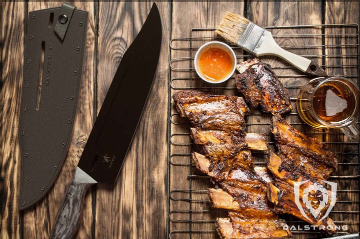 Dalstrong delta wolf series 10 inch chef knife with black blade and sheath beside cooked ribs.
