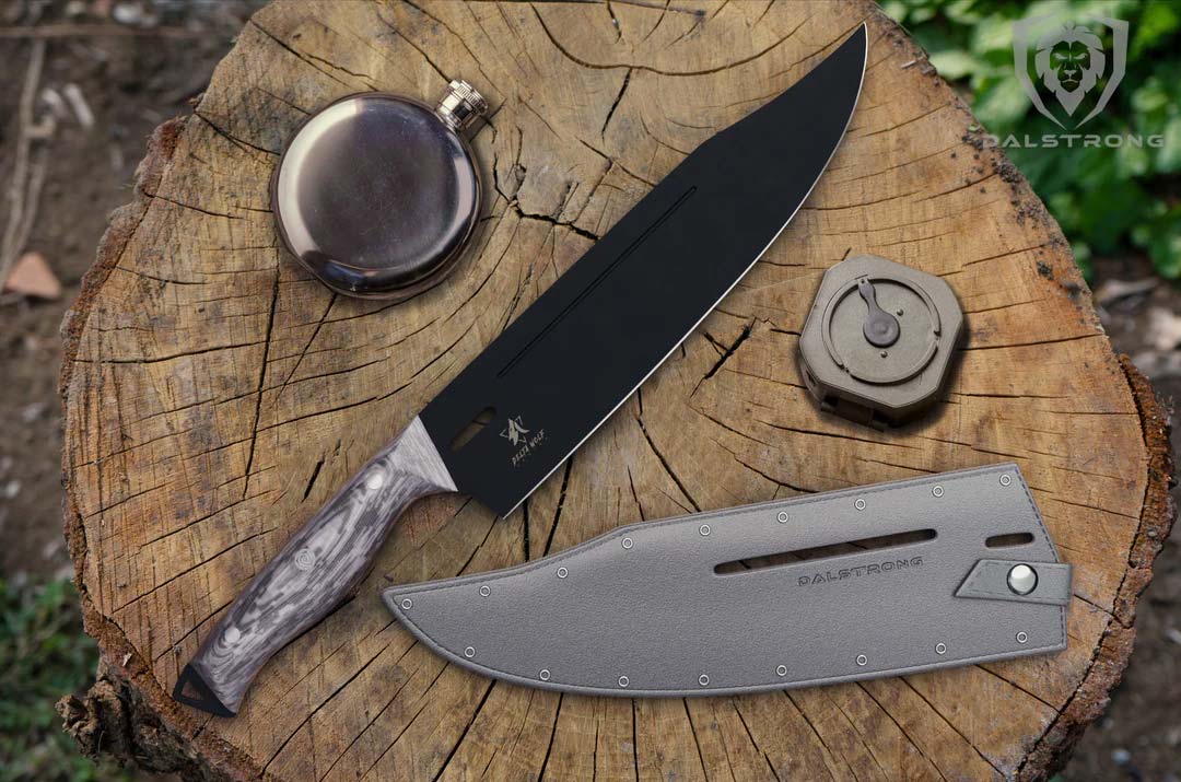 Dalstrong delta wolf series 10 inch chef knife with black blade and sheath on top of a log.