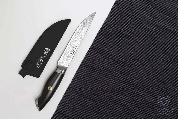Dalstrong omega series 5 inch steak knife set with it's black sheath beside a black cloth.