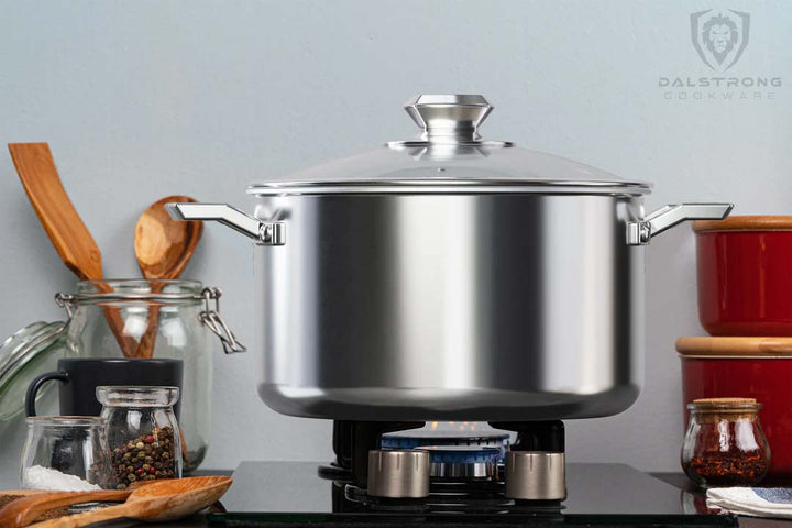 Dalstrong oberon series 5 quart sauce pot with silver color on a burning stovetop.