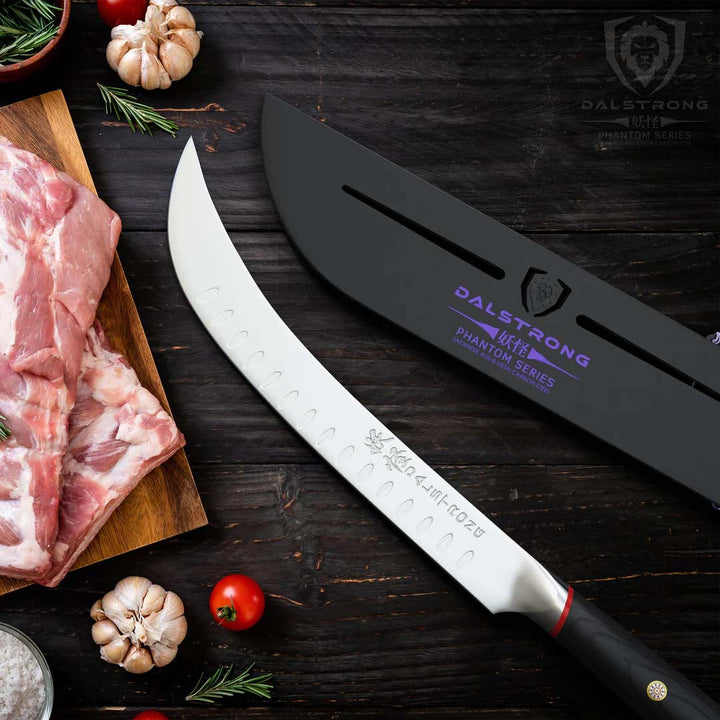 Dalstrong phantom series 10 inch butcher knife with pakka wood handle and black sheath beside two cuts of meat on a cutting board.