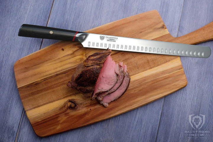 Dalstrong phantom series 12 inch slicer knife with pakka wood handle and slices of meat on a cutting board.