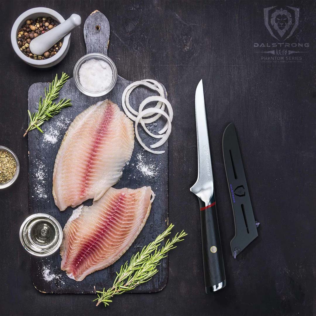 Dalstrong phantom series 6 inch boning knife with pakka wood handle and black sheath beside two fillets of fish.