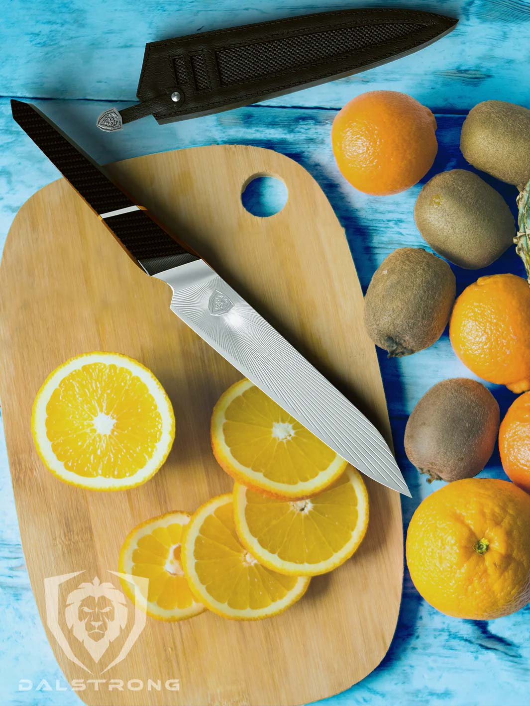 Dalstrong quantum 1 series 6 inch utility knife with dragon skin handle and black sheath beside slices of orange on a cutting board.