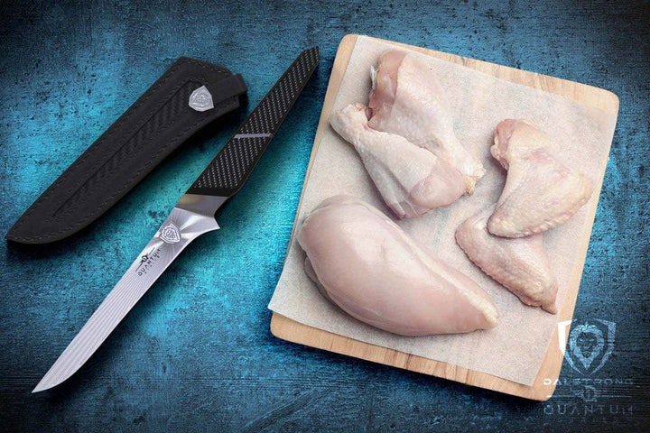 Dalstrong quantum 1 series 6 inch boning knife with dragon skin handle and five cuts of chicken on a cutting board.