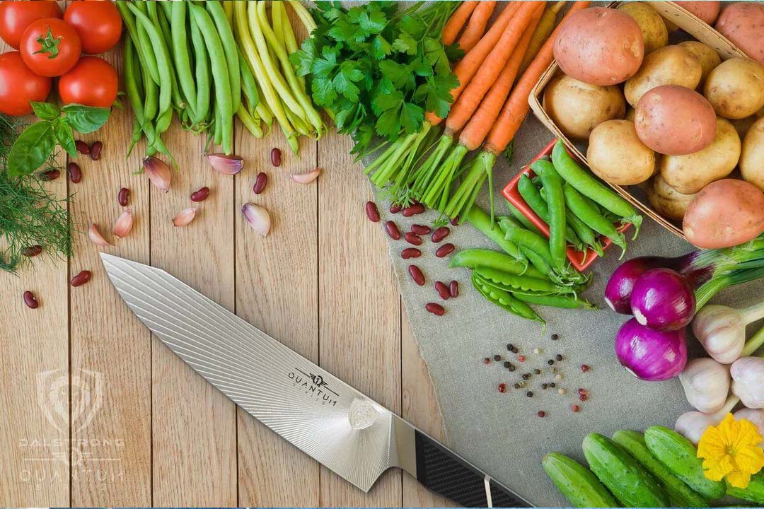 Dalstrong quantum 1 series 8 inch chef knife with dragon skin handle surrounded by vegetables on a table.