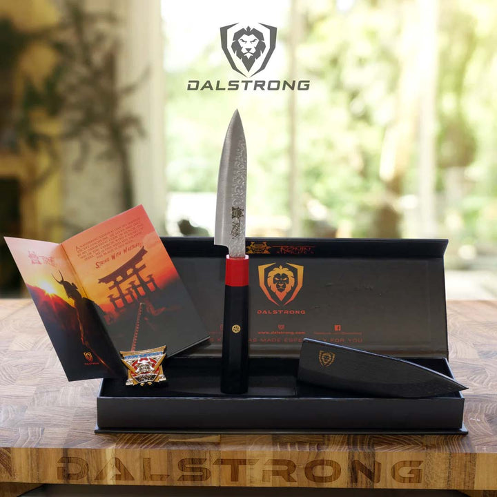 Dalstrong ronin series 4.5 inch paring knife with black handle and sheath outside it's premium packaging.