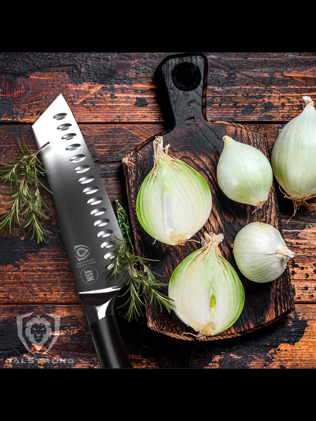 Dalstrong vanquish series 7 inch santoku knife with black handle and onions cut in half on a cutting board.