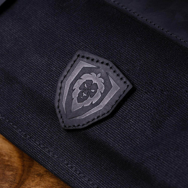 Dalstrong 12oz heavy-duty canvas and leather night master black nomad knife roll showcasing the dalstrong logo.