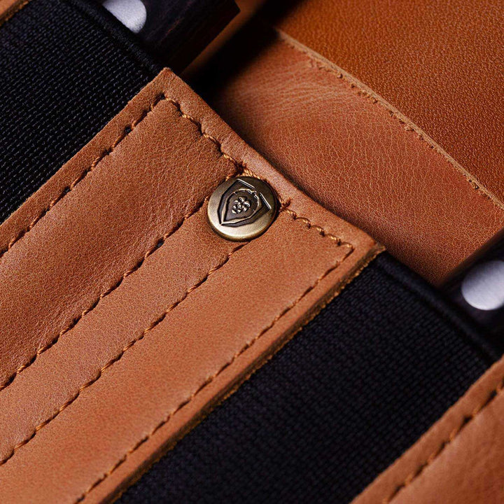Dalstrong california brown full grain leather vagabond knife roll featuring it's pockets and dalstrong logo on a pin.