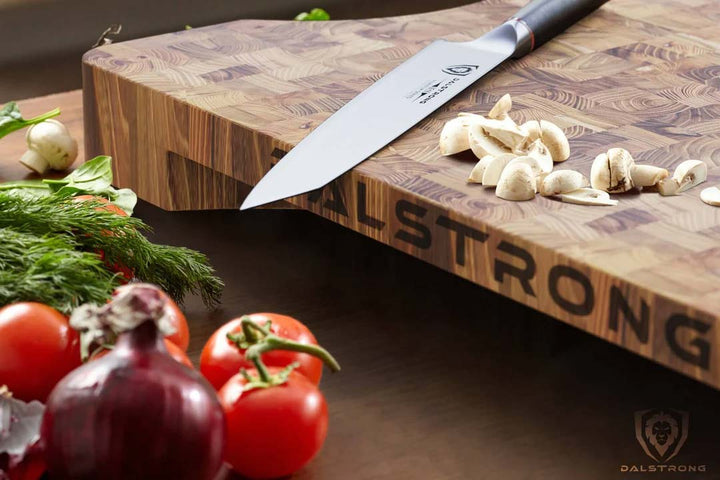 Dalstrong lionswood colossal teak cutting board with tomatoes and mushrooms.