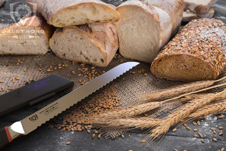 Dalstrong phantom series 9 inch serrated bread knife with pakka wood handle and five differernt breads.
