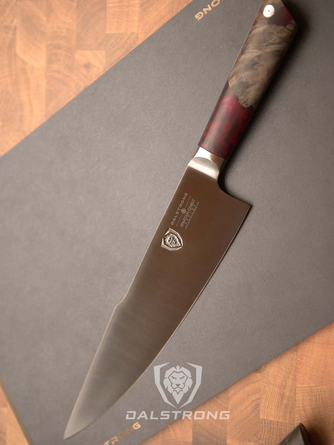 Dalstrong spartan ghost series 8 inch chef knife on a cutting board.