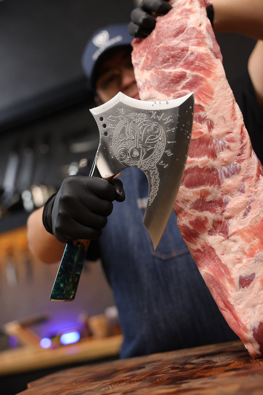Valhalla Meat Axe held beside a rack of ribs