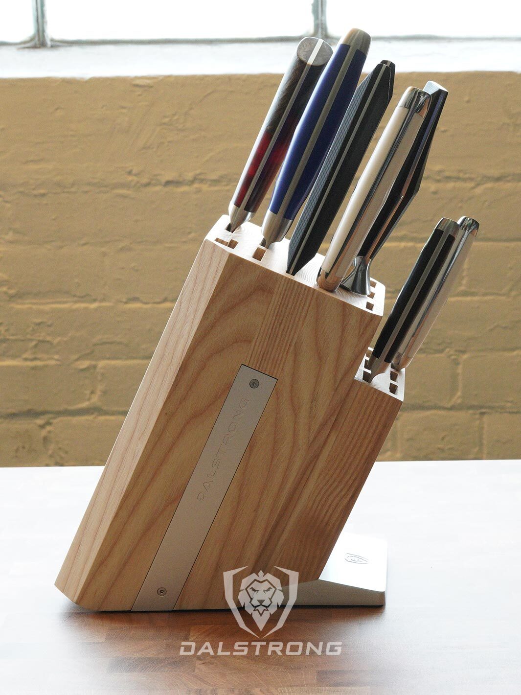 Dalstrong 18 slots universal knife block featuring it's wooden block with seven knives inside.