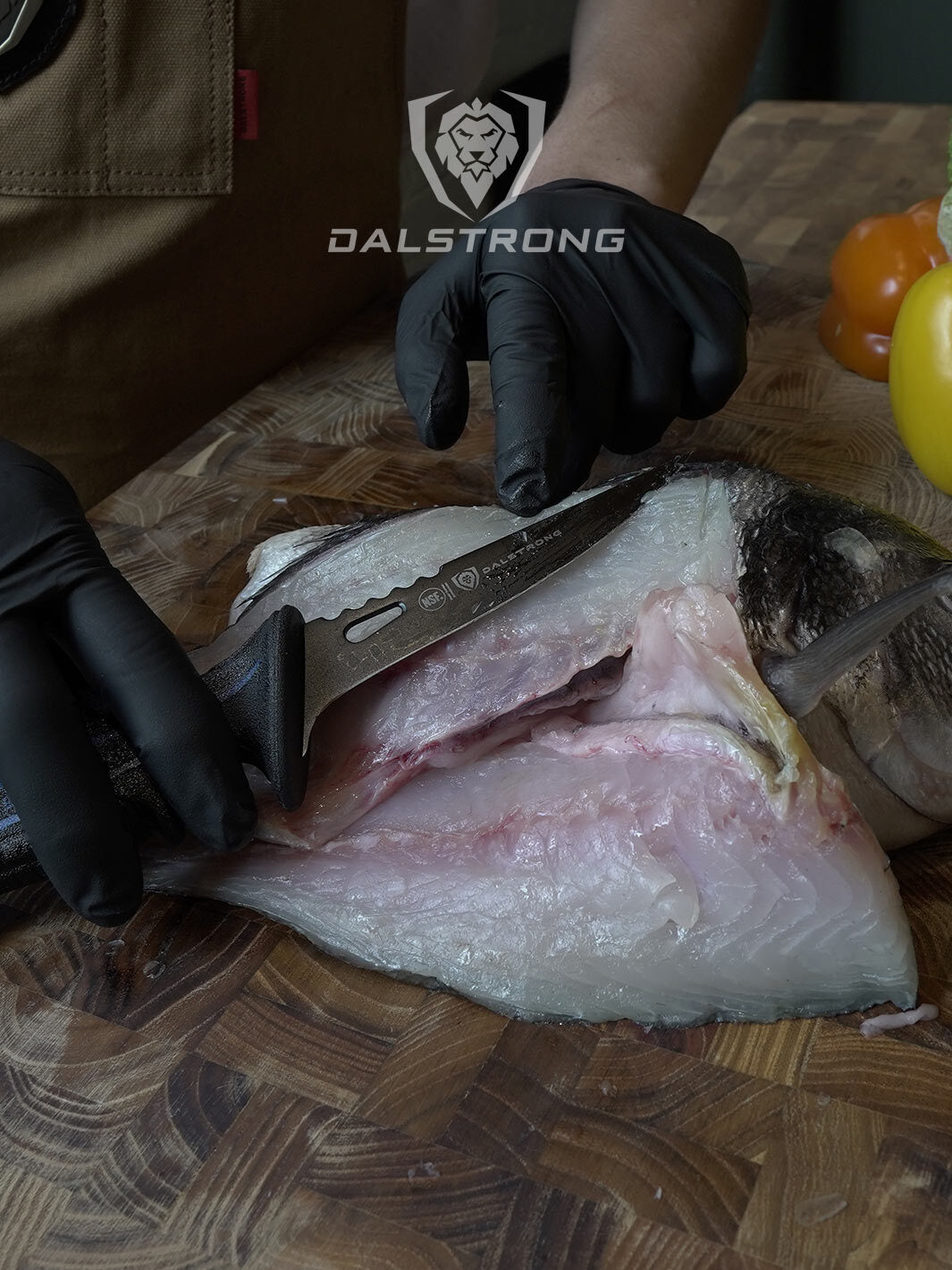Dalstrong night shark series 4.7 inch fillet knife with water proof handle with a fillet fish on a cutting board.