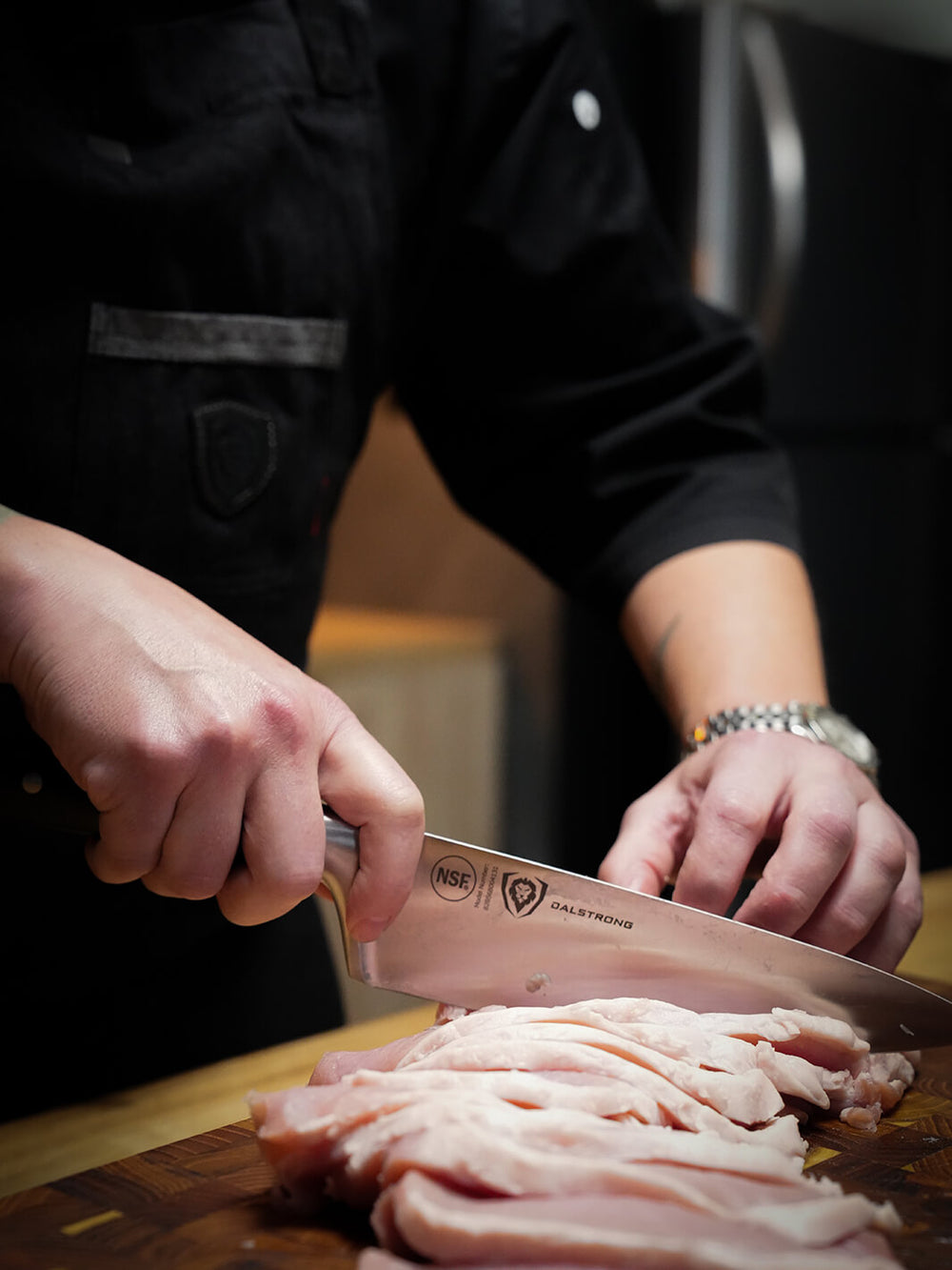 Chef slicing cooked chicken with an 8-inch Gladiator chef knife