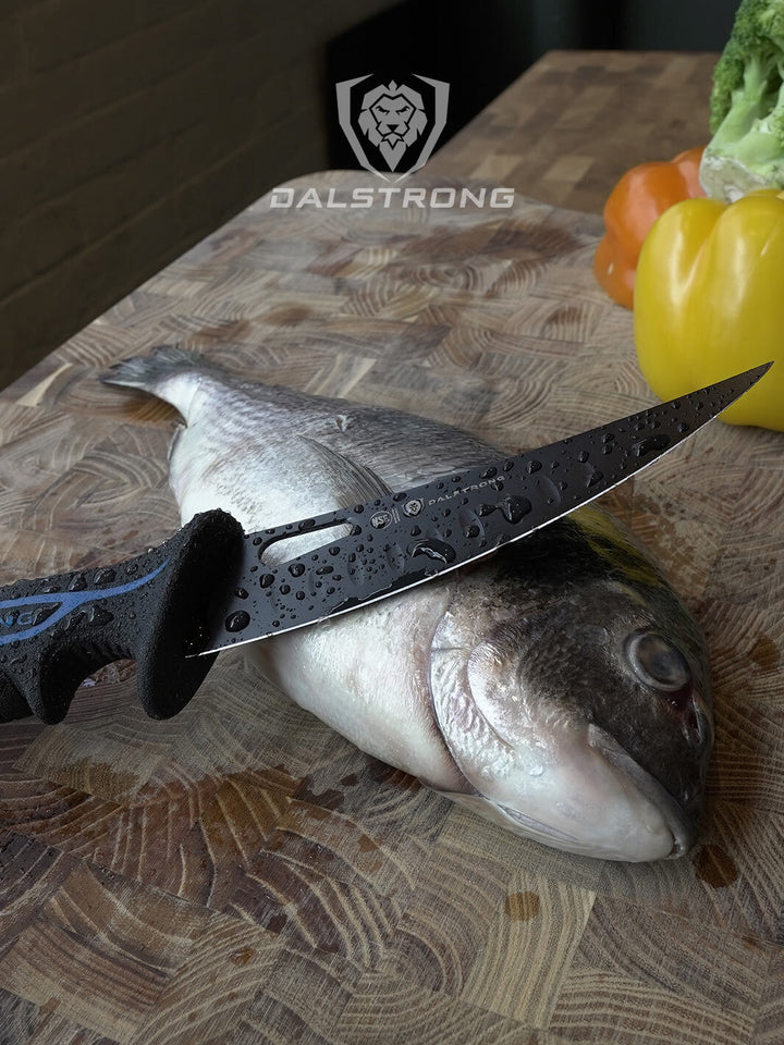 Dalstrong night shark series 6 inch curved boning knife with water proof handle on top of a fish.