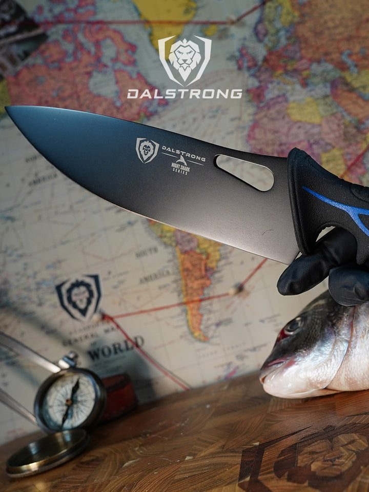 Dalstrong night shark series 8 inch chef knife with shark skin handle above a cutting board with fish.
