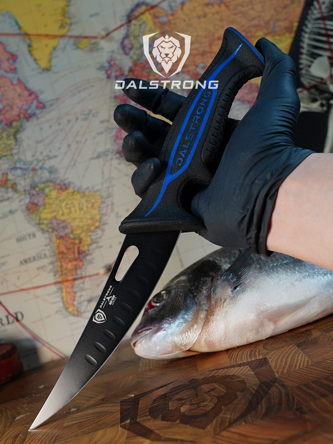 Dalstrong night shark series 6 inch curved boning knife with water proof handle on a cutting board with fish.