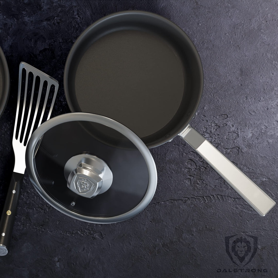 Dalstrong oberon series 3 quart stock pot eterna non-stick with lid and spatula at the side.