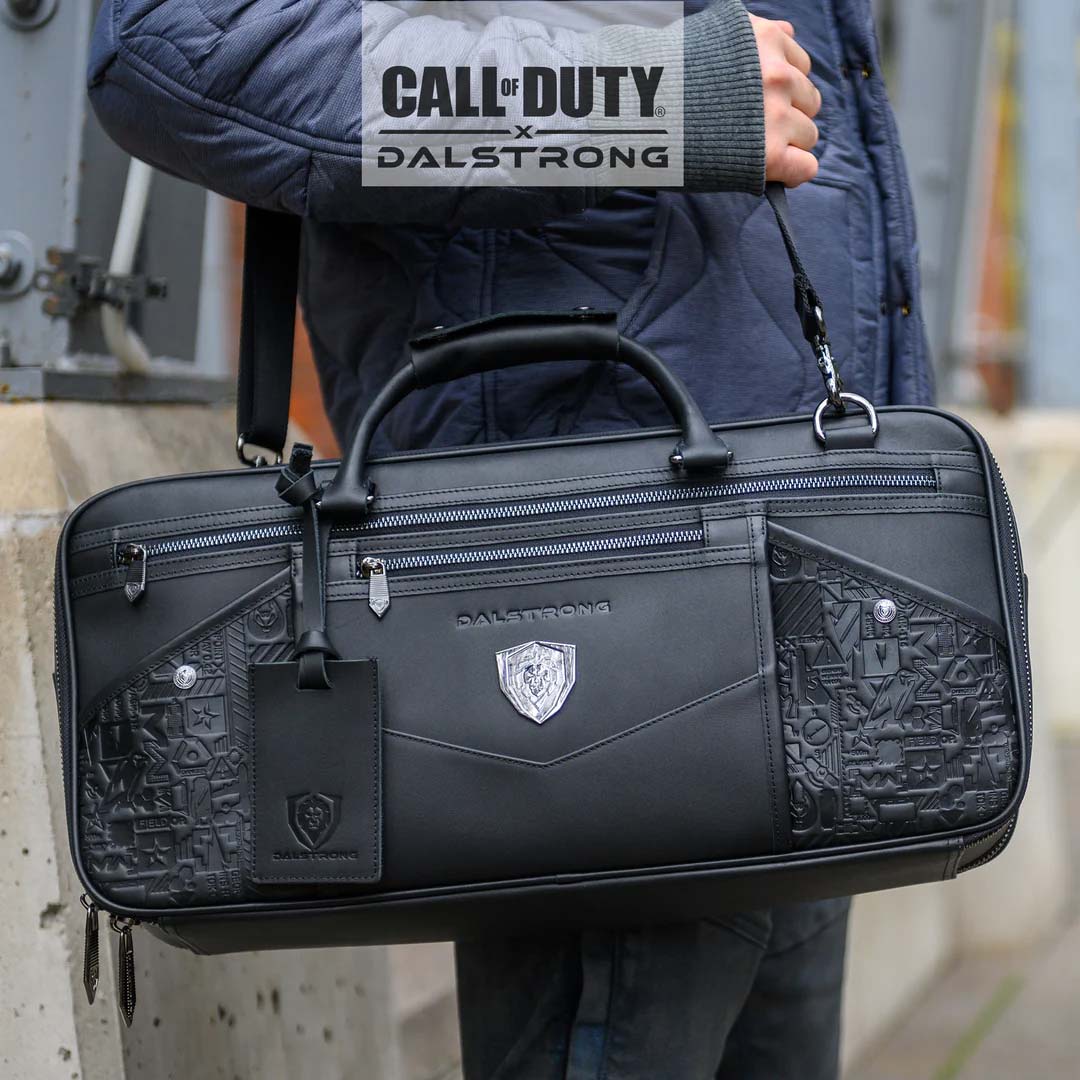 A man with Dalstrong call of duty exclusive collector and limited edition black genuine leather knife bag on it's side.