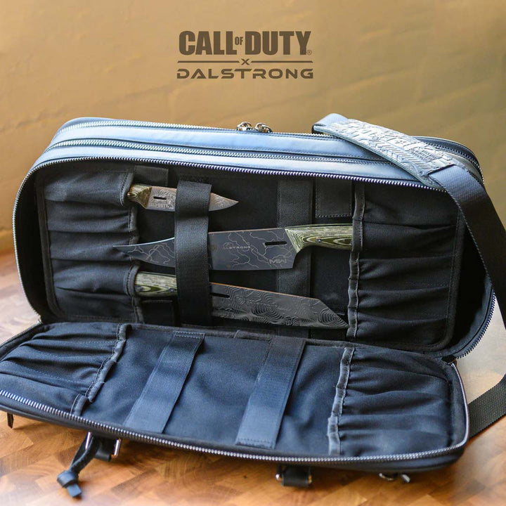 Dalstrong call of duty exclusive collector and limited edition black genuine leather knife bag with knives inside.