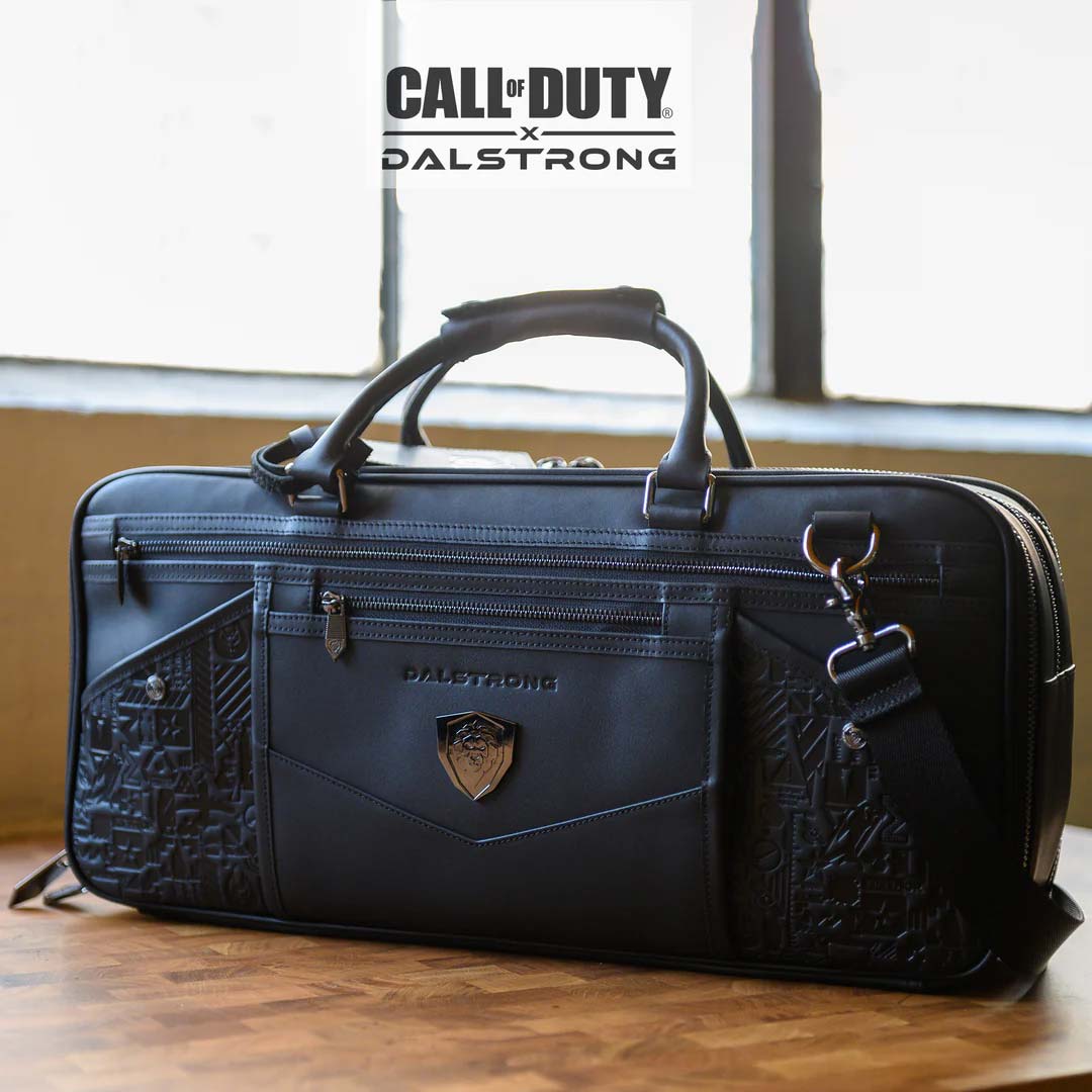 Dalstrong call of duty exclusive collector and limited edition black genuine leather knife bag on a cutting board.