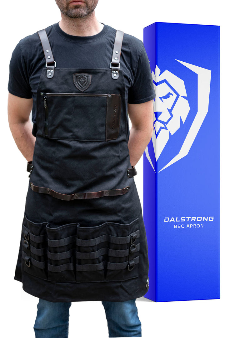 Dalstrong heavy-duty waxed canvas bbq apron in front of it's premium packaging.
